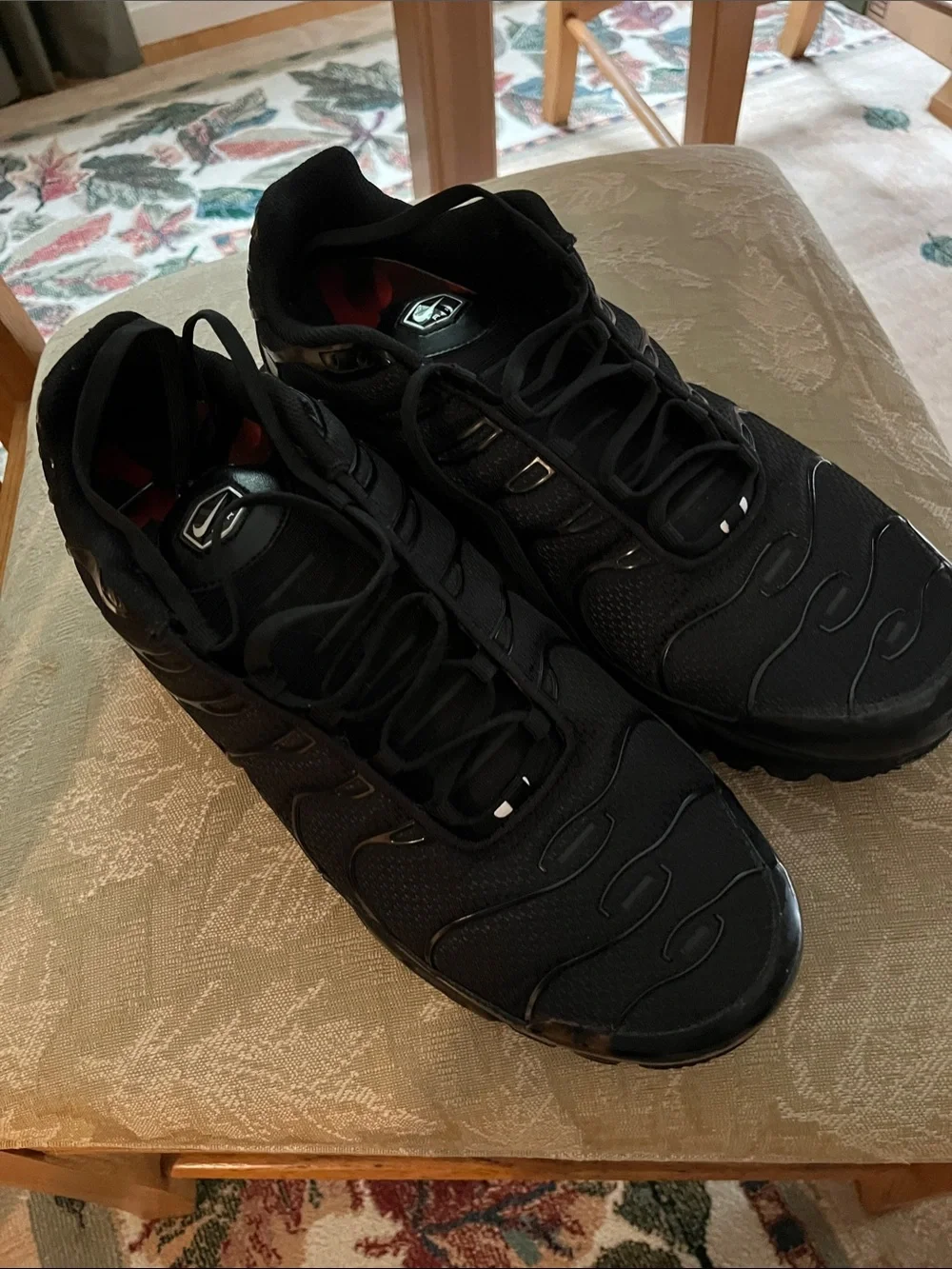 Nike Air Max Plus (Men’s) Triple Black Sneakers with Subtle Red Interior Accents